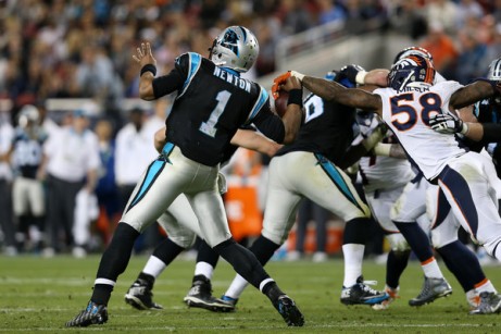 Von Miller gets one of his two strip sacks of Cam Newton. (Getty Images)